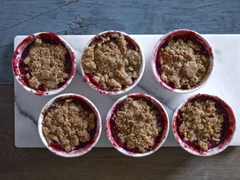 Six bowls of fruit crisps.