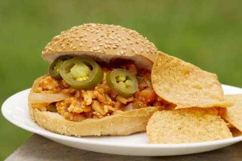 Ground turkey sloppy joe burger on sesame seed bun with corn chips