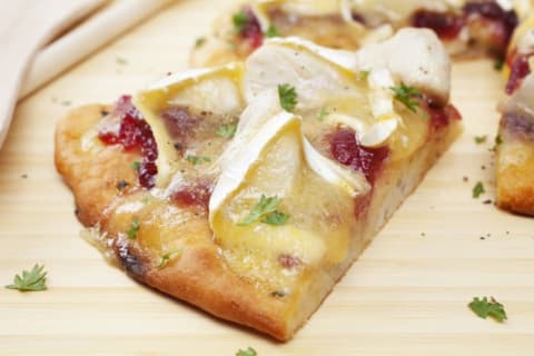 Slice of cheese and cranberry pizza.