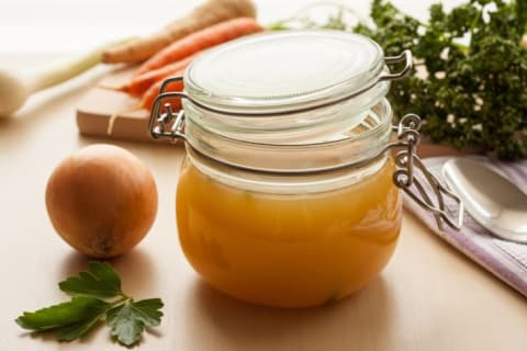 Glass jar of soup stock.