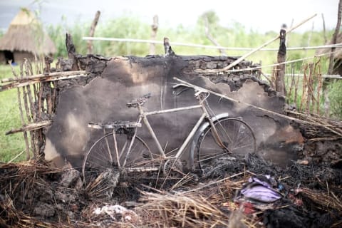 A burned house and bicycle in South Sudan.