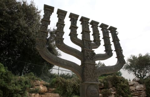 A stone menorah outside the knesset.