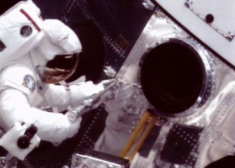 Astronaut Jeff Hoffman works on the Hubble Space Telescope in 1993.