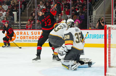 Mar 11, 2023; Raleigh, North Carolina, USA; Vegas Golden Knights goaltender Jonathan Quick (32) defenseman Brayden McNabb (3) and Carolina Hurricanes right wing Jesse Puljujarvi (13) watch the shot during the second period at PNC Arena. Mandatory Credit: James Guillory-USA TODAY Sports