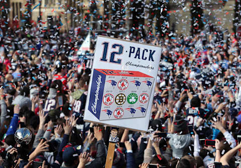 BOSTON, MA – FEBRUARY 5: A fan holds up a homemade sign reading “12 Pack of Championships,” depicting the 12 titles won by the Patriots, Red Sox, Celtics and Bruins since 2002, in Copley Square during the New England Patriots Super Bowl LIII victory parade in Boston on Feb. 5, 2019. (Photo by Jim Davis/The Boston Globe via Getty Images)