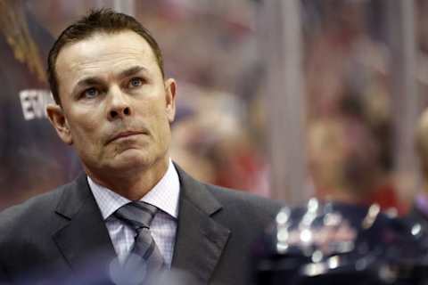 Apr 1, 2014; Washington, DC, USA; Washington Capitals head coach Adam Oates watches from behind the bench against the Dallas Stars in the second period at Verizon Center. The Stars won 5-0. Mandatory Credit: Geoff Burke-USA TODAY Sports