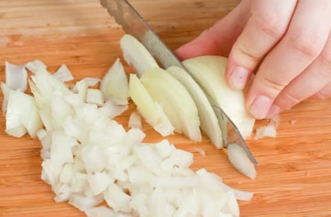 Dicing onions on a cutting board