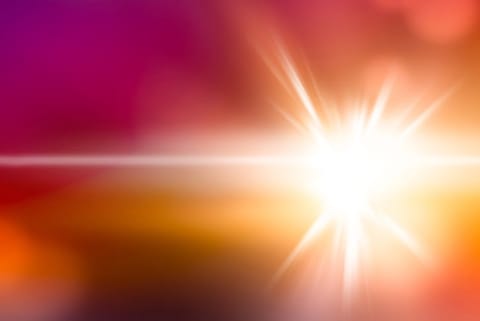 A beam of light on a pink and yellow background