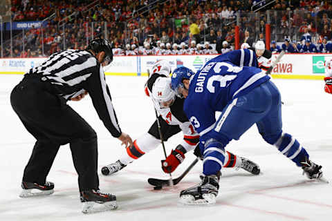 NEW YORK, NY – JANUARY 06: Adam Henrique #14 of the New Jersey Devils takes a face-off against Frederik Gauthier #33 of the Toronto Maple Leafs. (Photo by Andy Marlin/NHLI via Getty Images).