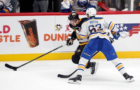 Sep 28, 2023; Pittsburgh, Pennsylvania, USA; Pittsburgh Penguins center Sidney Crosby (87) moves the puck against Buffalo Sabres right wing Isak Rosen (63) during the second period at PPG Paints Arena. Mandatory Credit: Charles LeClaire-USA TODAY Sports