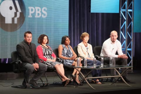 Producers and participants of Genealogy Roadshow speaking onstage during a panel discussion in 2013