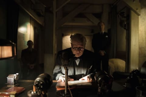 Gary Oldman, as Winston Churchill, delivering a speech at the desk in his bedroom in the Cabinet War Rooms.