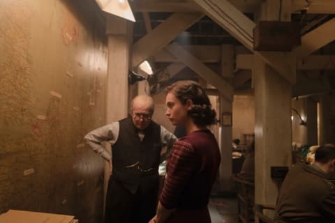 Gary Oldman and Lily James as Elizabeth Layton, Churchill's secretary, in the recreated Map Room in Darkest Hour (2017).