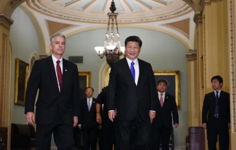 Senat Sergeant at Arms Frank Larkin (L) escorts China's president Xi Jinping during a visit to Capitol Hill.