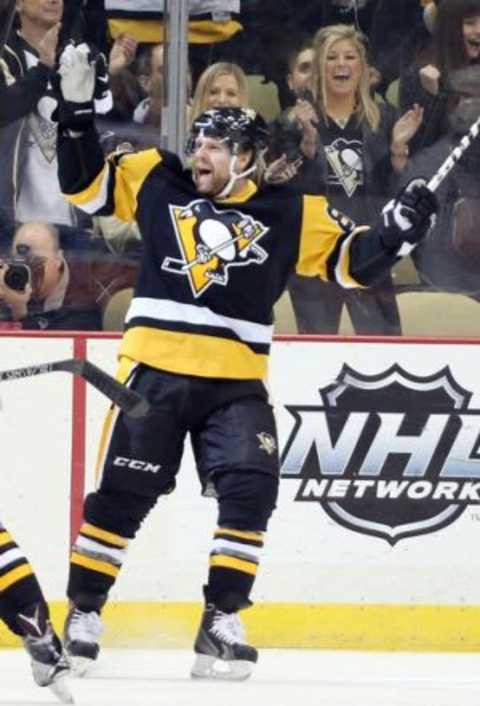 Jan 2, 2016; Pittsburgh, PA, USA; Pittsburgh Penguins right wing Phil Kessel (81) reacts after scoring a goal against the New York Islanders during the first period at the CONSOL Energy Center. Mandatory Credit: Charles LeClaire-USA TODAY Sports