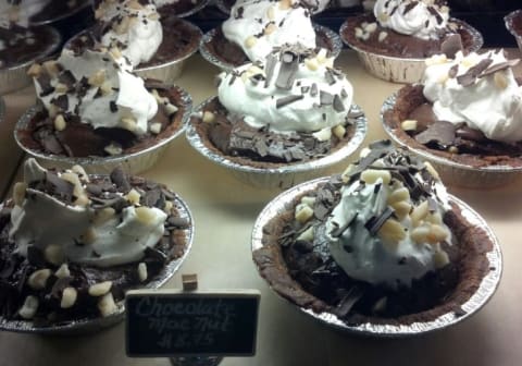 Rows of small chocolate macadamia nut pies.