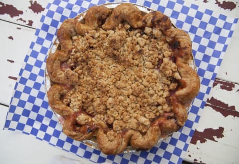 Large crumb pie on a blue checkered background.