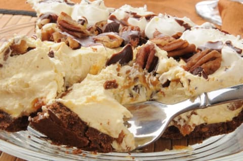 Slice of caramel turtle fudge ice cream pie.