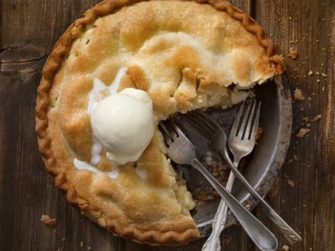 Large apple pie with a slice missing.