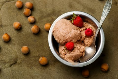 Bowl of ice cream with hazelnuts.