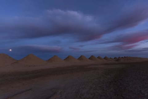 The Moon rises over a salt evaporation project on Bristol Dry Lake in California.