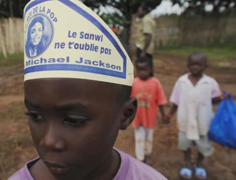 A young child wears a hat memorializing Michael Jackson, which reads "Sanwi African region will not forget you," on August 1, 2009 in Krindjabo, an Ivory Coast village where Jackson was crowned king in 1992.