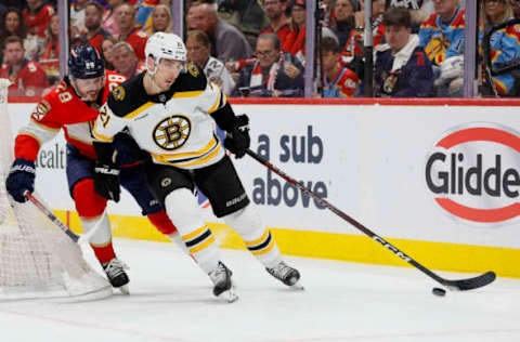 Apr 21, 2023; Sunrise, Florida, USA; Boston Bruins right wing Garnet Hathaway (21) moves the puck ahead of Florida Panthers defenseman Josh Mahura (28) during the second period in game three of the first round of the 2023 Stanley Cup Playoffs at FLA Live Arena. Mandatory Credit: Sam Navarro-USA TODAY Sports