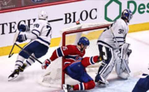 Apr 28, 2021; Montreal, Quebec, CAN; Montreal Canadiens center Jesperi Kotkaniemi (15) falls into Toronto Maple Leafs goaltender Jack Campbell (36) net during the third period at Bell Centre. Mandatory Credit: Jean-Yves Ahern-USA TODAY Sports