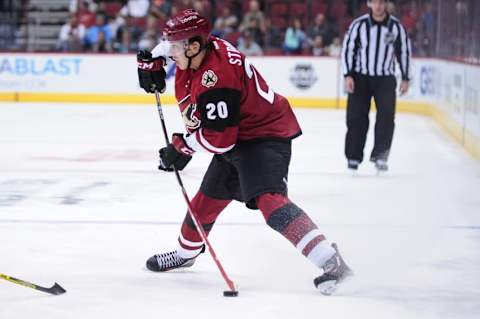 Oct 2, 2015; Glendale, AZ, USA; Arizona Coyotes center Dylan Strome (20) passes the puck during the second period against the San Jose Sharks at Gila River Arena. Mandatory Credit: Matt Kartozian-USA TODAY Sports