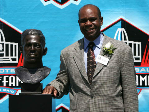 Steven Towns, Fritz Pollard's grandson, standing next to Pollard's Pro Football Hall of Fame bust in 2005.