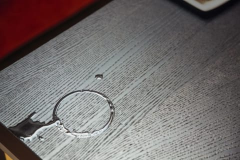 Rings of water on wooden table.