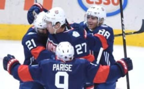 Sep 20, 2016; Toronto, Ontario, Canada; Team USA forward Ryan McDonagh (27) is greeted by team mates Zach Parise (9), Patrick Kane (88) and Derek Stepan (21) after scoring against Team Canada during preliminary round play in the 2016 World Cup of Hockey at Air Canada Centre. Mandatory Credit: Dan Hamilton-USA TODAY Sports