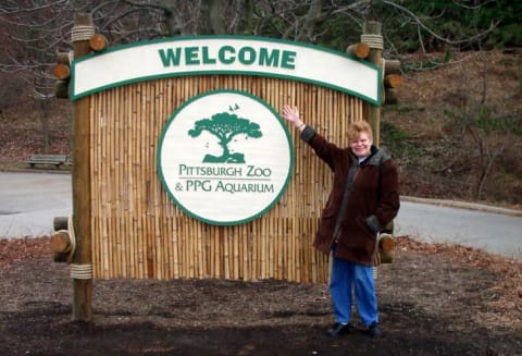 A visitor poses beside the sign in 2006.