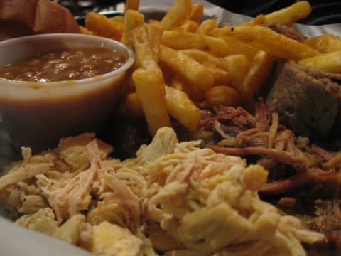 Plate of barbecue, chili, and fries.