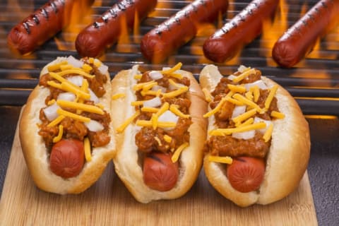 Hot dogs with chili on a grill