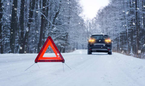 Car on side of road with snow