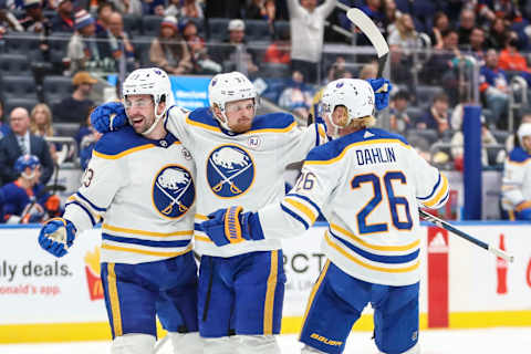 Oct 14, 2023; Elmont, New York, USA; Buffalo Sabres center Casey Mittelstadt (37) celebrates with defensemen Mattias Samuelsson (23) and Rasmus Dahlin (26) after scoring a goal in the third period at UBS Arena. Mandatory Credit: Wendell Cruz-USA TODAY Sports