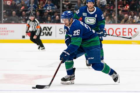 VANCOUVER, BC – FEBRUARY 08: Antoine Roussel # 26 of the Vancouver Canucks skates with the puck in NHL action. (Photo by Rich Lam/Getty Images)