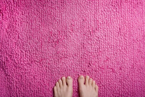 Feet on a pink rug