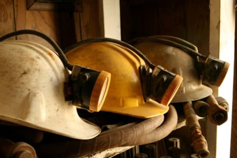 An image of mining helmets on a shelf.