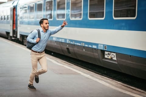 Young man runs to catch a missed train