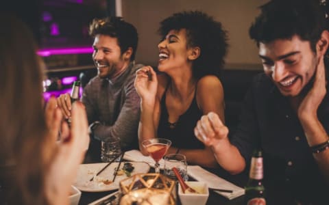 Group of friends laughing in a restaurant