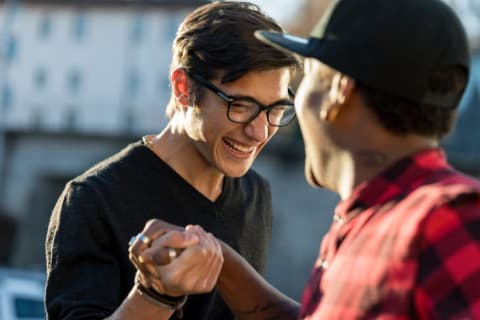 Two guys laughing and shaking hands