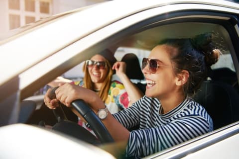 Two girls laughing in a car