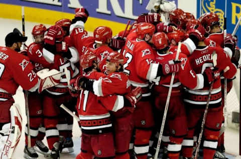 Rod Brind’Amour #17 of the Carolina Hurricanes hugs teammate Justin Williams  (Photo by Grant Halverson/Getty Images)