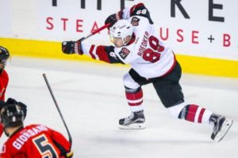 Jan 7, 2016; Calgary, Alberta, CAN; Arizona Coyotes left wing Mikkel Boedker (89) shoot the puck against the Calgary Flames during the second period at Scotiabank Saddledome. Arizona Coyotes won 2-1. Mandatory Credit: Sergei Belski-USA TODAY Sports