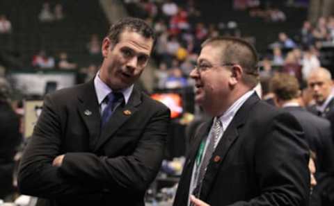 Special Assistant to the General Manager Craig Conroy and General Manager Jay Feaster share a conversation during day one of the 2011 NHL Entry Draft at Xcel Energy Center on June 24, 2011 in St Paul, Minnesota.