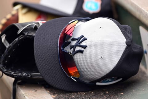 Mar 8, 2016; Jupiter, FL, USA; A detail shot of a New York Yankees baseball cap and glove is seen on the steps during a spring training game against the Miami Marlins at Roger Dean Stadium. Mandatory Credit: Steve Mitchell-USA TODAY Sports