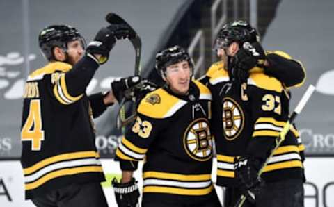 Mar 11, 2021; Boston, Massachusetts, USA; Boston Bruins defenseman Jarred Tinordi (84) center Brad Marchand (63) celebrate a short handed goal by center Patrice Bergeron (37) during the first period against the New York Rangers at TD Garden. Mandatory Credit: Bob DeChiara-USA TODAY Sports