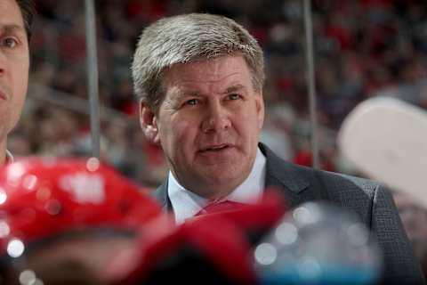 RALEIGH, NC – FEBRUARY 9: Head coach Bill Peters of the Carolina Hurricanes watches action on the ice from the bench area during an NHL game against the Vancouver Canucks on February 9, 2018 at PNC Arena in Raleigh, North Carolina. (Photo by Gregg Forwerck/NHLI via Getty Images)